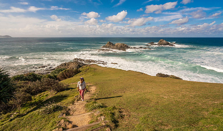 Photo of a person walking down the Three Sisters Walking Track towards the Three Sisters