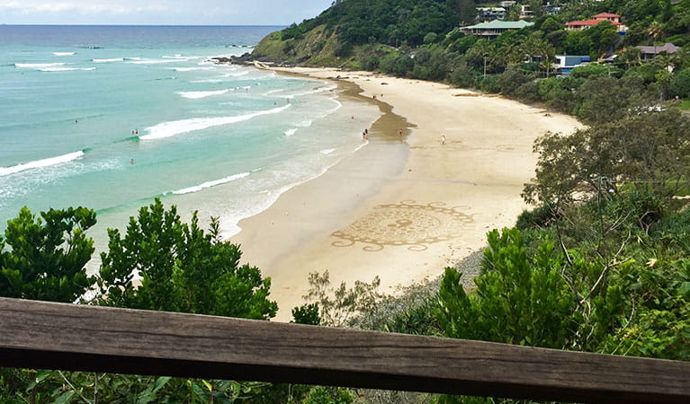 Photo of Wategos Beach taken looking down on it from a nearby lookout